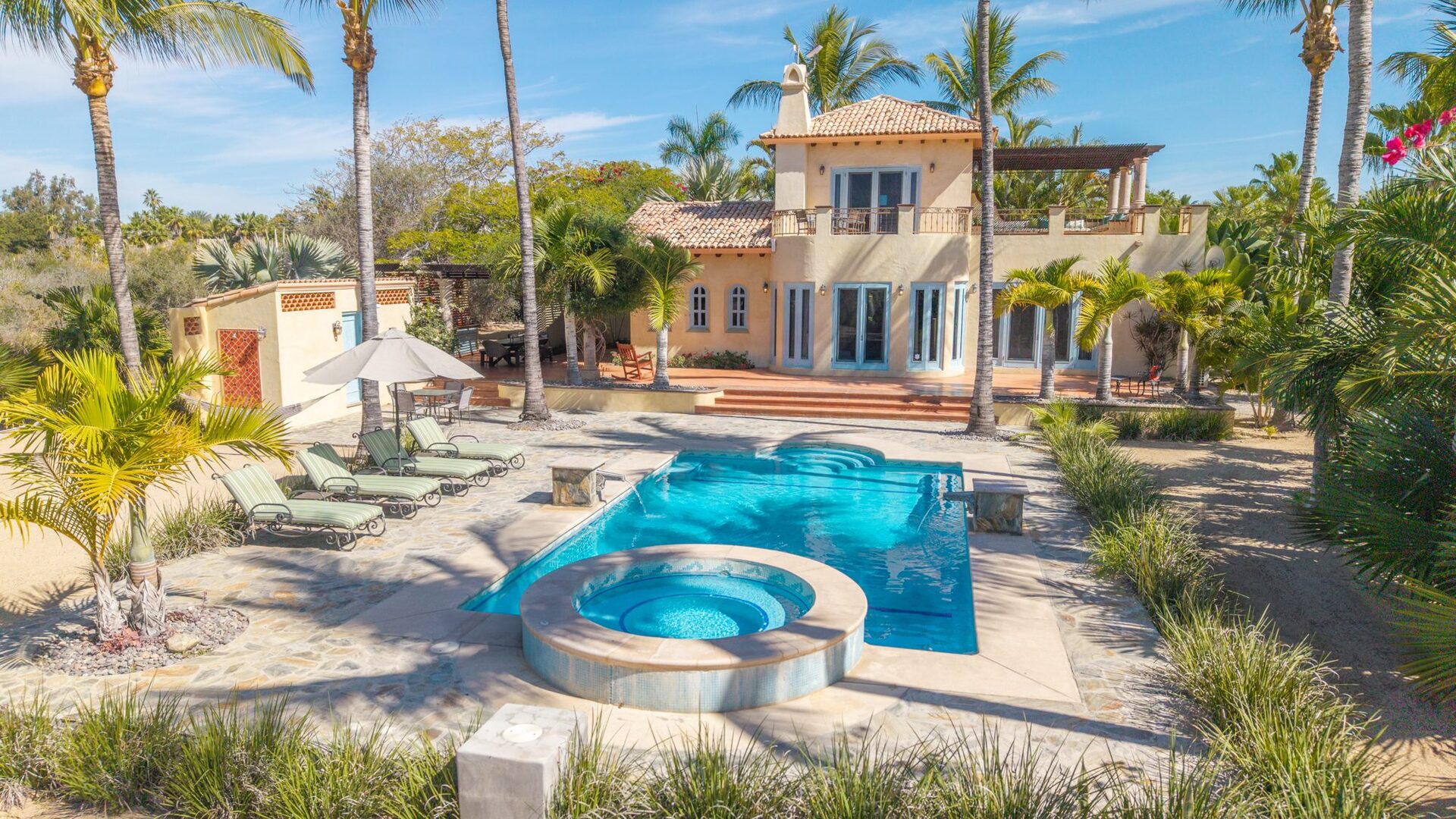 Aerial view of the pool, hot tub, and main house